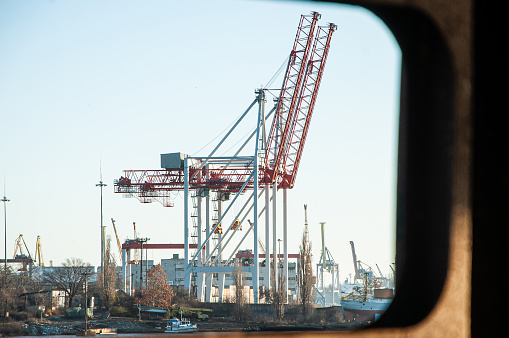 Cranes for loading onto ships in the seaport can be seen through the window from the ship.
