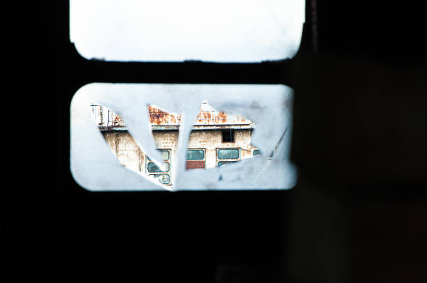 istock Torn film covering a broken window. Focus in the background on a rusty abandoned ship. 1450233986