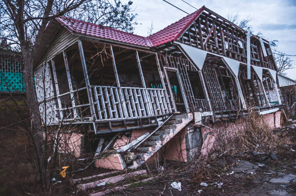 istock House tilted at an angle due to soil failure. Business failed. The resort complex. Gloomy abandoned buildings. 1450234813