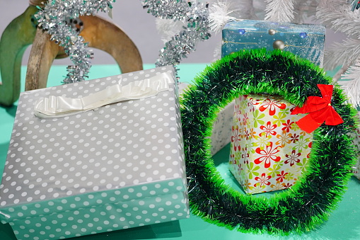 Christmas composition. Red poinsettia, cones, balls, gift box on a white background.