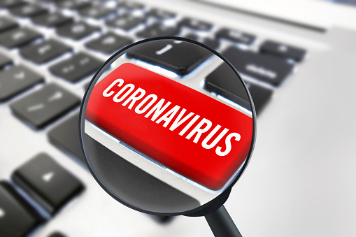 close up laptop key quoting “Coronavirus” with magnifying glass