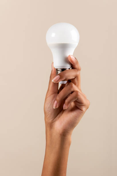 Crop African American woman showing light bulb stock photo