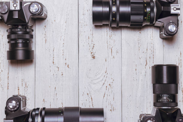 istock 4 old retro cameras lie on a wooden table 1450245636