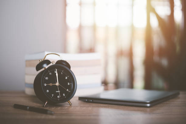 istock Alarm clock, laptop, books, all on the table,online training,distance learning,self learning,e-learning ,Educational or training courses, seminars,searching for information manually 1450248056