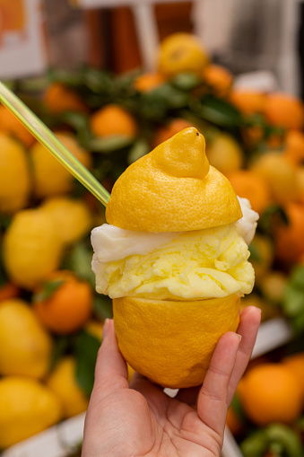 Amalfi lemon sorbet in a large lemon. National Italian dessert - ice cream. A walk through the narrow Italian streets.