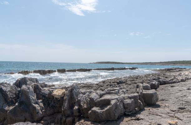 istock Splashing waves at the rocky coast in Kamenjak 1450249343
