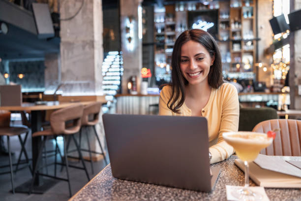 istock Woman using laptop at cafe 1450251396