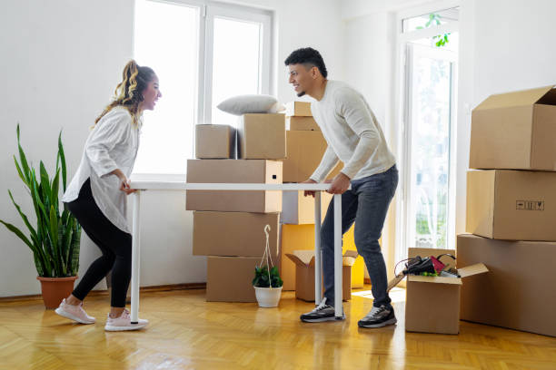istock Couple carrying table together 1450252948