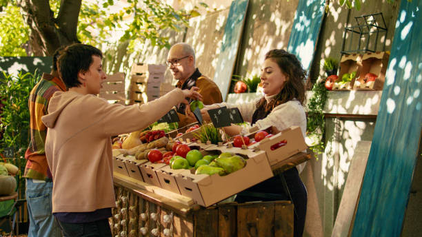 istock Young vendor giving free apple samples to clients 1450254254