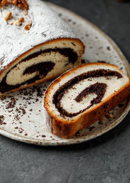 istock Christmas poppy seed cake. Poppy roll on dark background 1450256125