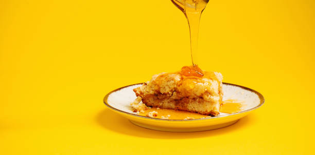 istock cake with honey on  plate on  yellow background 1450257825