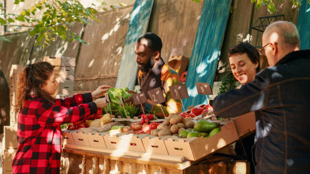 istock Client looking at fresh bio vegetables on farmers market counter 1450258661