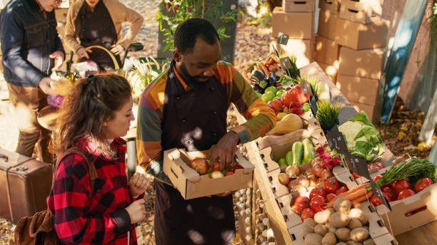 istock Small business owners choosing apples and veggies in box 1450259094