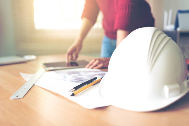 istock Safety helmets and drawing equipment of drafting engineers 1450262710