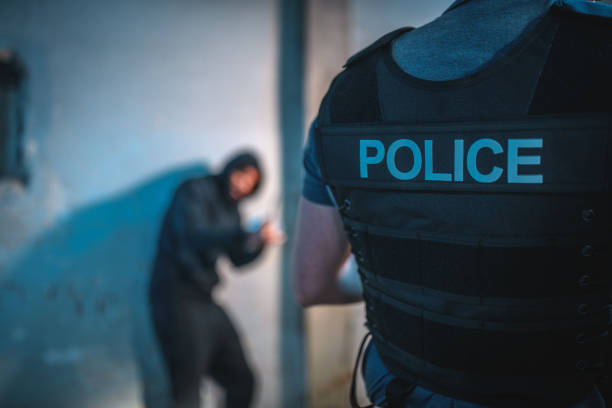 istock Policeman Catching A Criminal At Night 1450262882