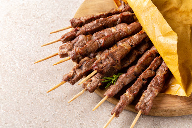 Arrosticini. Italian lamb skewers or kebabs cooked on a brazier. From the Italian region of Abruzzo and Molise. stock photo