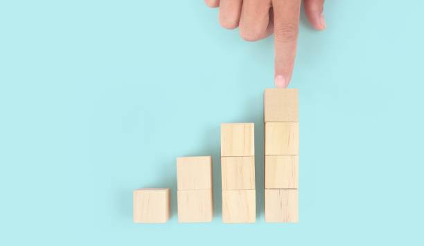 istock Business connecting piece of multi wood chart blocks steps in hand 1450263876