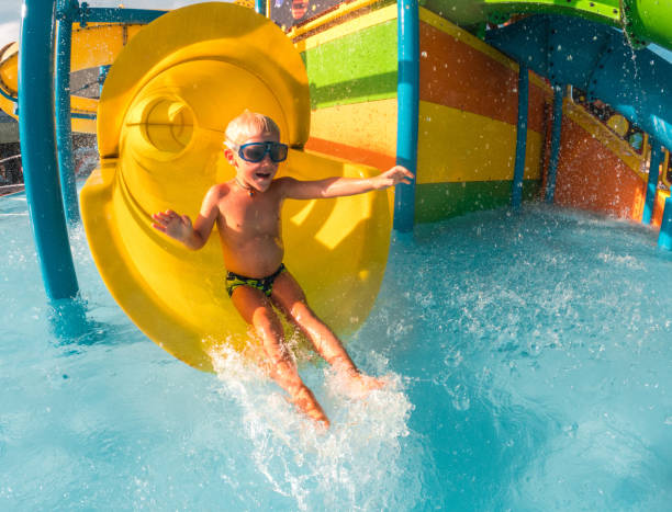 istock Little Kid Enjoys Sliding Into Water 1450264258