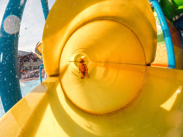 istock Happy Little Boy Using A Water Slide 1450264260