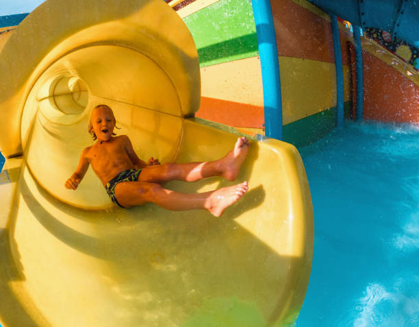 istock Happy Little Kid Enjoying The Water Slide 1450264262