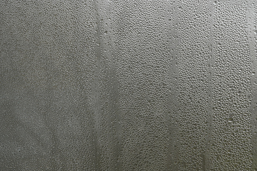 Water drops background. beautiful wet glass pattern. View from the window to the street.