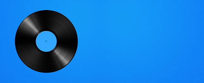 Vinyl record isolated on blue background. Horizontal banner. 3D illustration