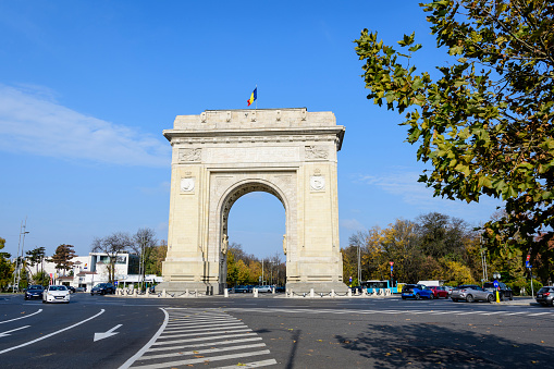 Bucharest, Romania - 6 November 2021:  Arcul de Triumf (The Arch Of Triumph) triumphal arch and landmark, located in the Northern part of the city on Kiseleff Road near King Michael I (Herastrau) Park