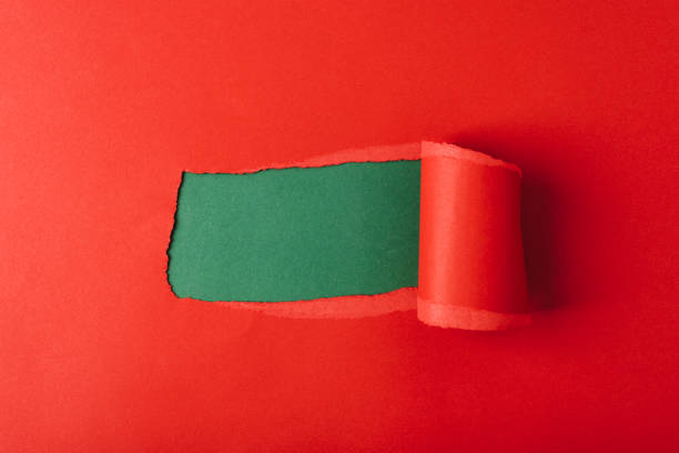 istock Hole in red paper on green background. Mockup 1450267002