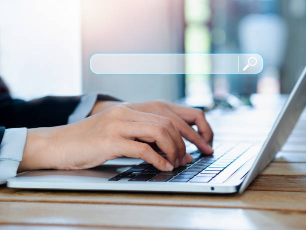 istock Search engine bar with  blank space for text on laptop computer using by businessperson. Data search technology optimization for information on website. Job searching on browsing internet concept. 1450267050