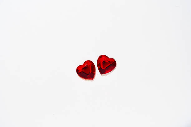 Love in valentine's day concept. Two heart shaped rubies over white background