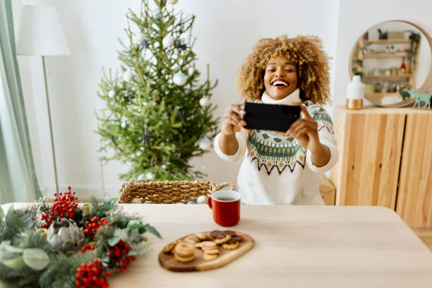 istock Woman on a video call while decorating Christmas tree 1450268882