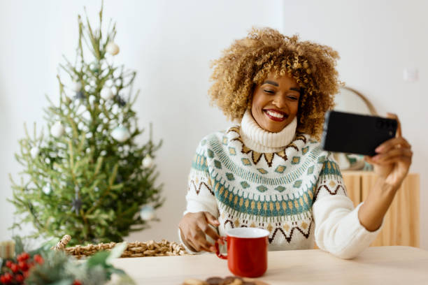 istock Woman on a video call while decorating Christmas tree 1450268889