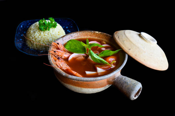 istock Soup tom yum with rice isolated on black background side view 1450268903