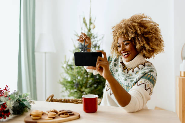 istock Woman on a video call while decorating Christmas tree 1450268919