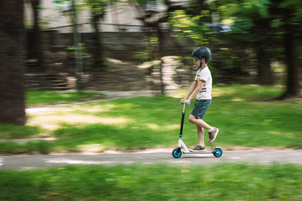 istock Little boy riding scooter 1450270509