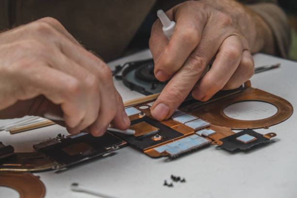 istock cleaning and replacing the old thermal paste with new one on the video processor chip. laptop maintenance. close-up. 1450270813