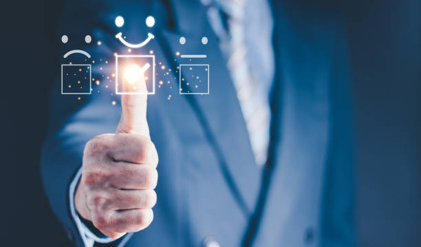istock Customer service evaluation best excellent business rating experience concept. smiling man using a smartphone and pressing face emoticon smile in satisfaction on virtual touch screen. 1450271981