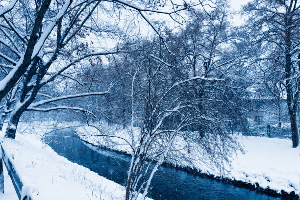 istock River flowing in a snowy winter forest. 1450273550