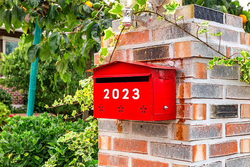 The mailbox in front of the house with 2023 on it