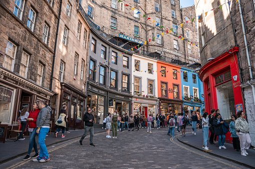 Edinburgh, Scotland, United kingdom - 06/18/2022: Photograph of a street with old buildings taken in Scotland. The buildings are multi-storey, old and brown in color, showing the Scottish way of life.