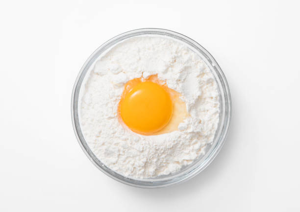 istock Bowl plate with flour and egg yolk on white background. 1450279959