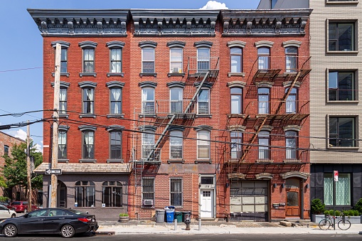New York City, United States – August 20, 2019: Historic brick townhouse apartment buildings in Greenpoint, New York City.