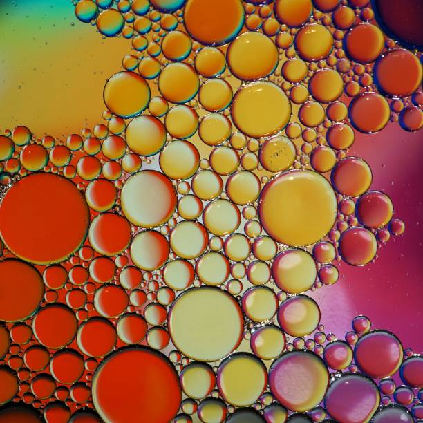 istock multi colored oil circles on the water, colorful background 1450281140