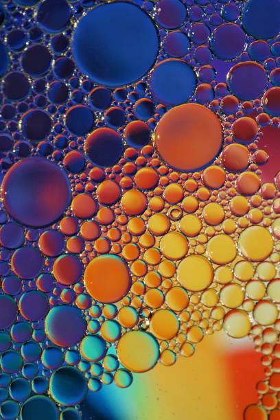 istock multi colored oil circles on the water, colorful background 1450281145