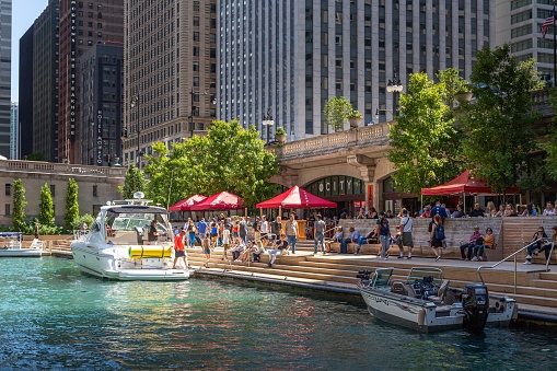 Chicago, United States – August 30, 2019: People walking along The Cove, a part of the Riverwalk public space on the Chicago River.