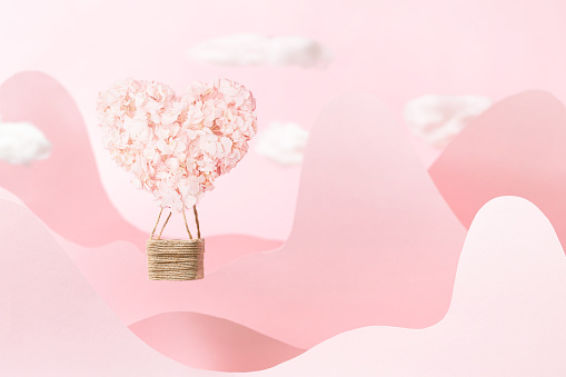 Valentine's Day background with pink heart balloon on pink background with copy space