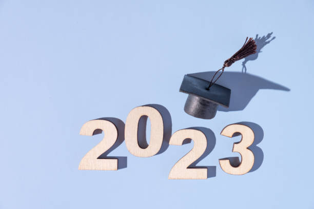 istock Class of 2023 concept. Numbers 2023 with black graduated cap on colored background 1450286249