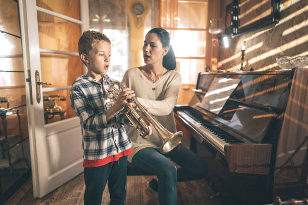 istock Boy learning to play trumpet 1450286789