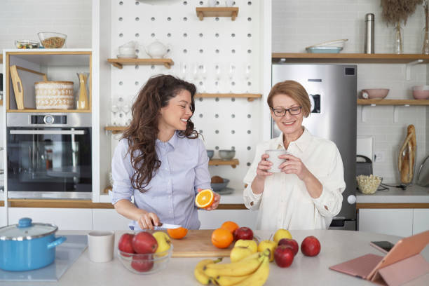 istock Mother and daughter having fun in the kitchen 1450286997