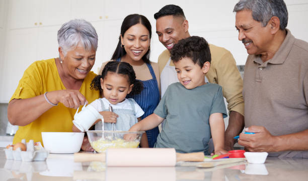 istock Baking, cooking and big family, together in kitchen while teaching and learning, bonding and life skill development. Mexican family in home, grandparents and parents with children, happy and love. 1450290294